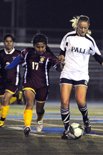 Katie Van Daalen Wetters (right) dribbles past a Roosevelt defender during the Dolphins' annual Holiday Showcase last Friday night at Stadium by the Sea. Rich Schmitt/Staff Photographer
